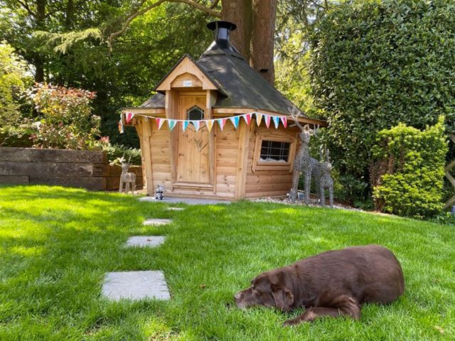 Arctic Cabin decorated with bunting for Summer BBQ Party, dog in foreground