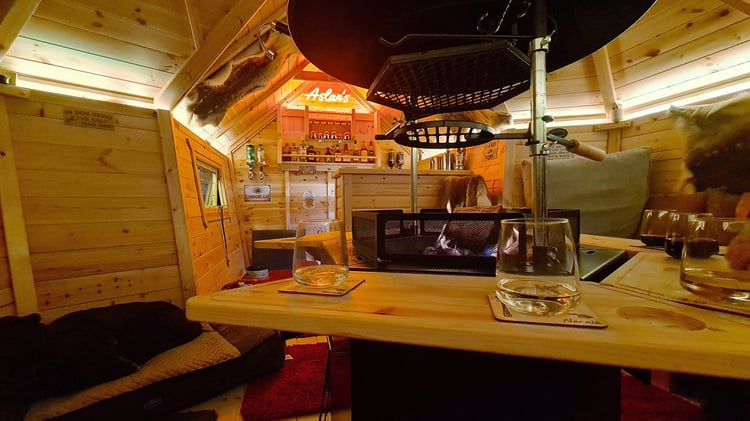 Interior of Arctic Bar Garden Bar with neon sign and drinks on tray tables