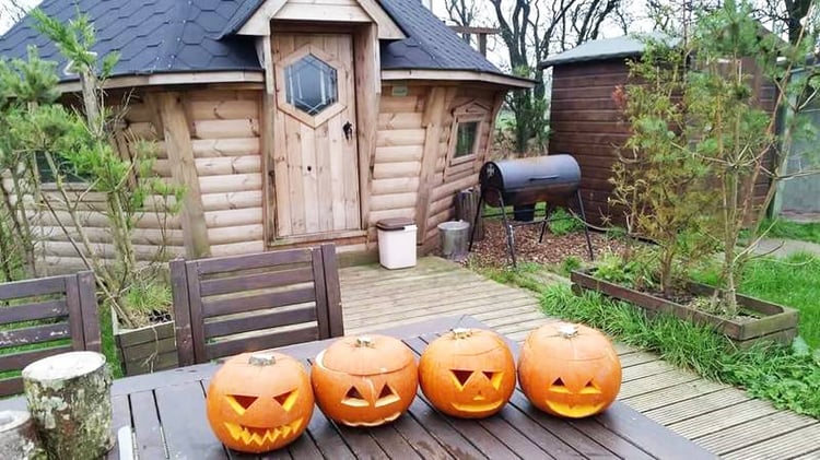 Arctic Cabin at Halloween, with pumpkins outside