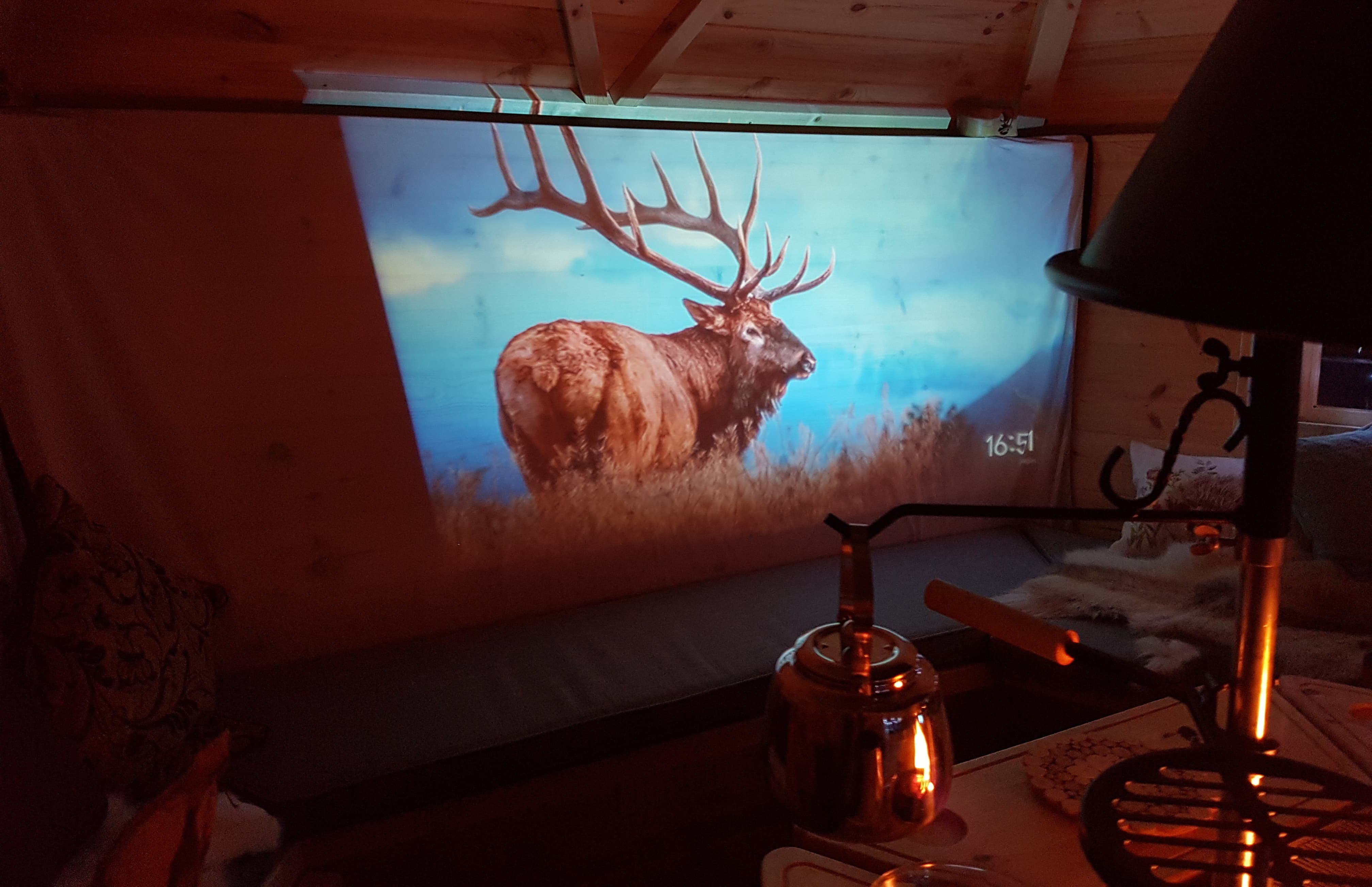 Interior of timber BBQ grill cabin with home cinema screen