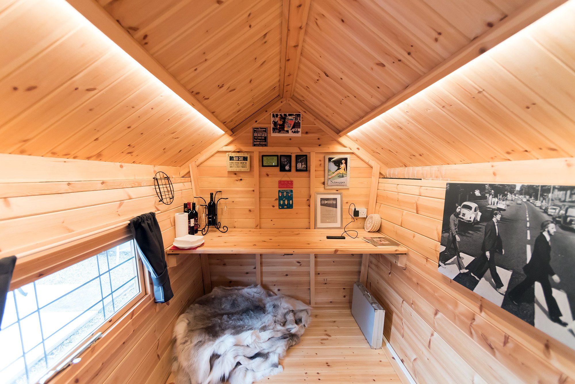 Inside Arctic Cabin Timber Garden Office with desk, rugs & pictures