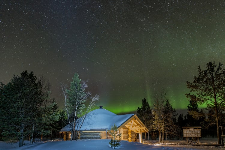 Traditional Scandinavian BBQ hut under the Northern Lights