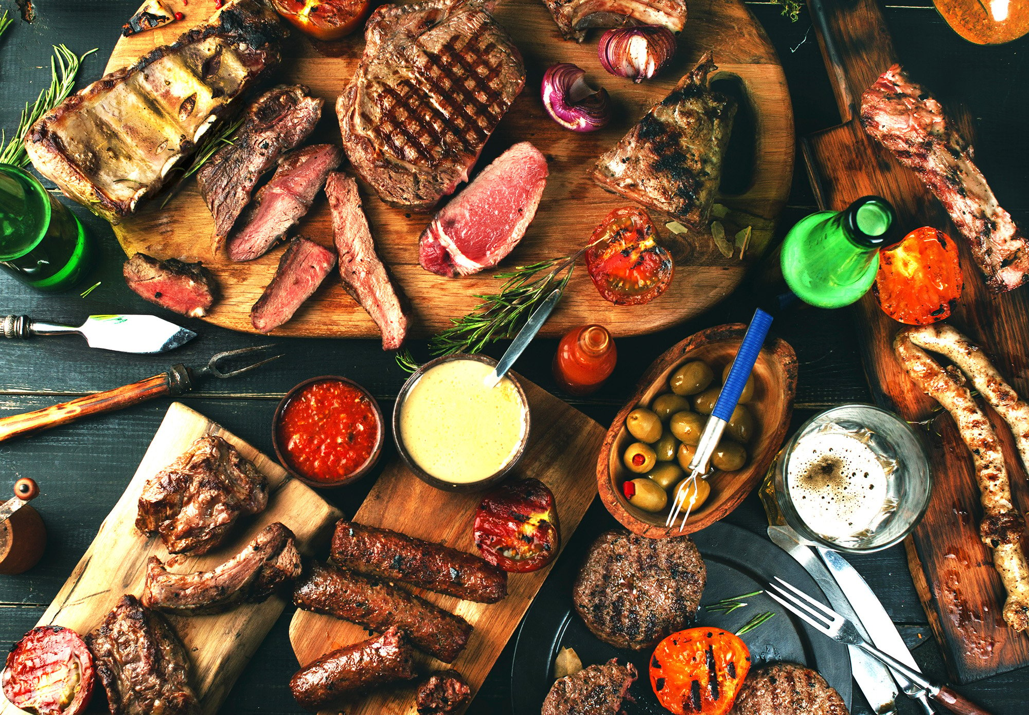 Selection of BBQ food and ingredients on a wooden chopping board