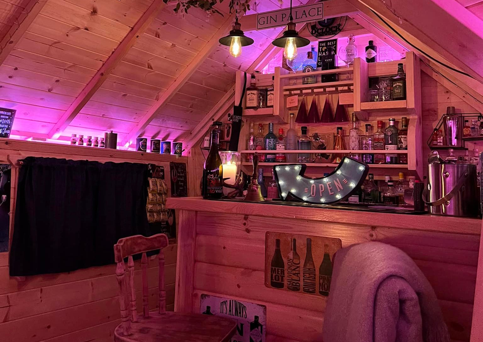 Arctic Cabin garden bar inside, featuring bar, drinks rack and 'open' sign