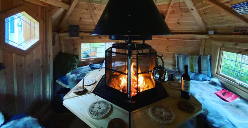 Roaring fire inside an Arctic Cabins grill house