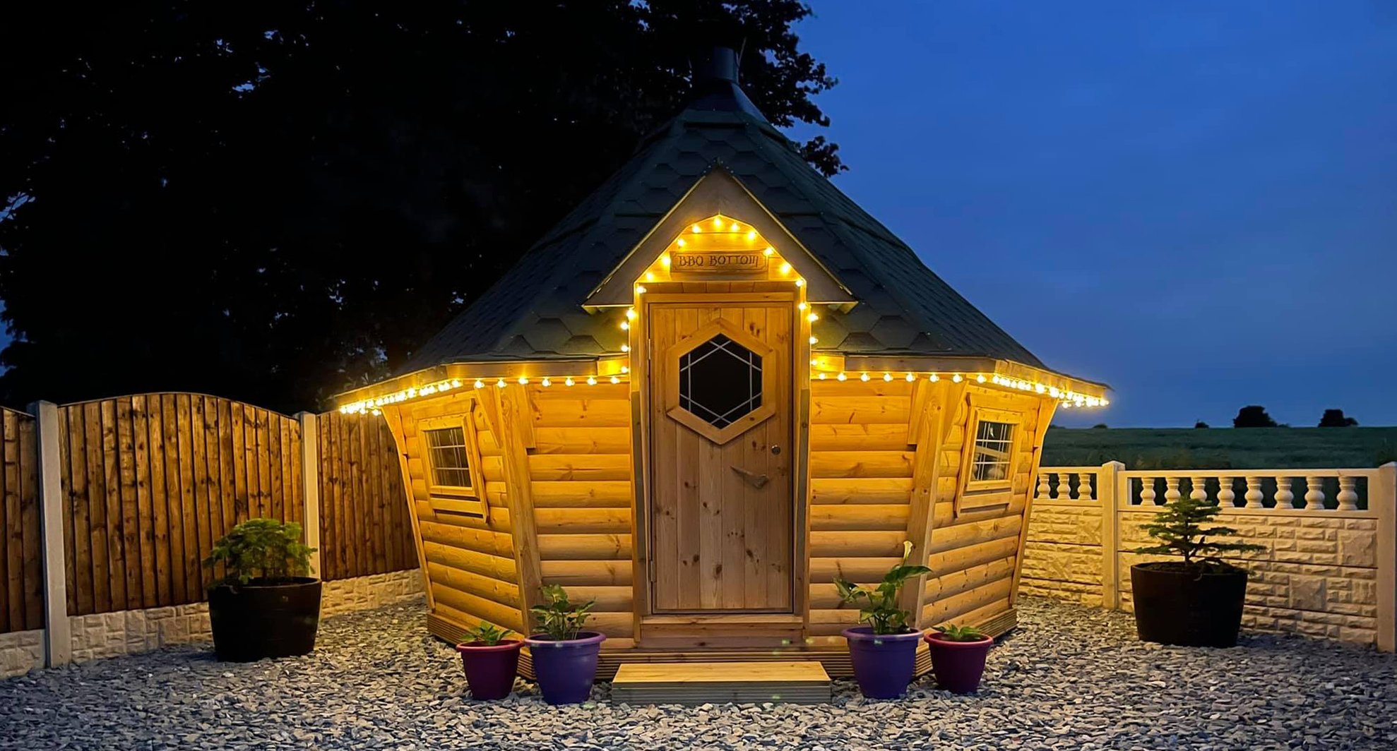 Nighttime shot of a 10m² Arctic Cabin with fairy lights