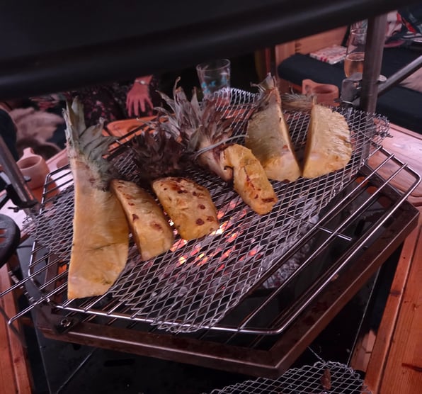 Grilled pineapple on the grill of a BBQ hut