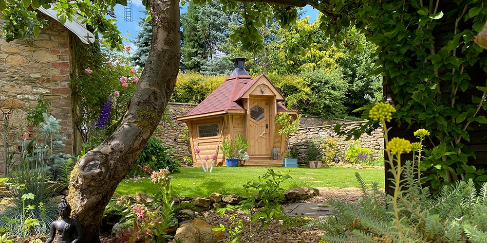 small garden cabin with bbq in traditional garden