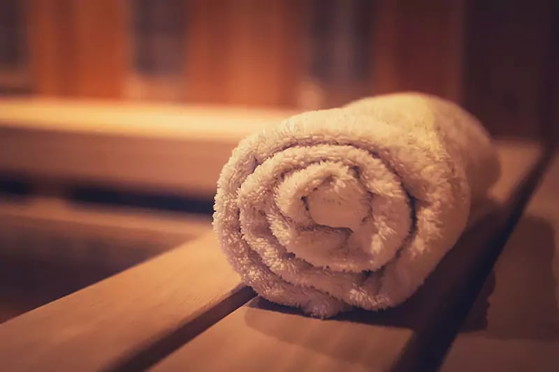 towel rolled up inside a sauna cabin for the garden