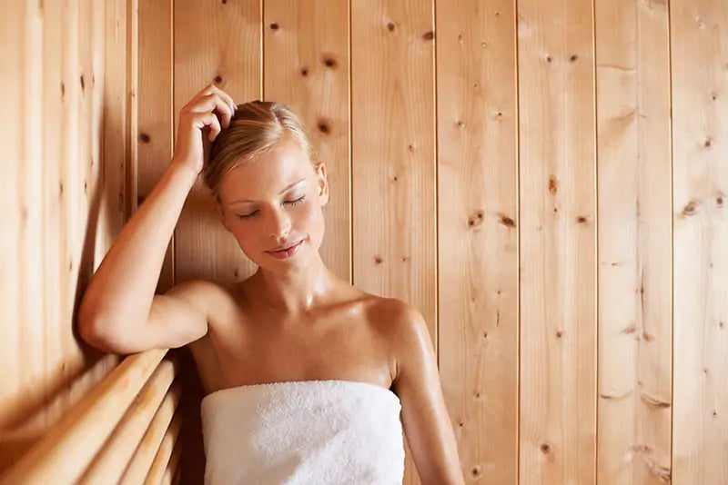 woman sat up relaxing inside an arctic sauna