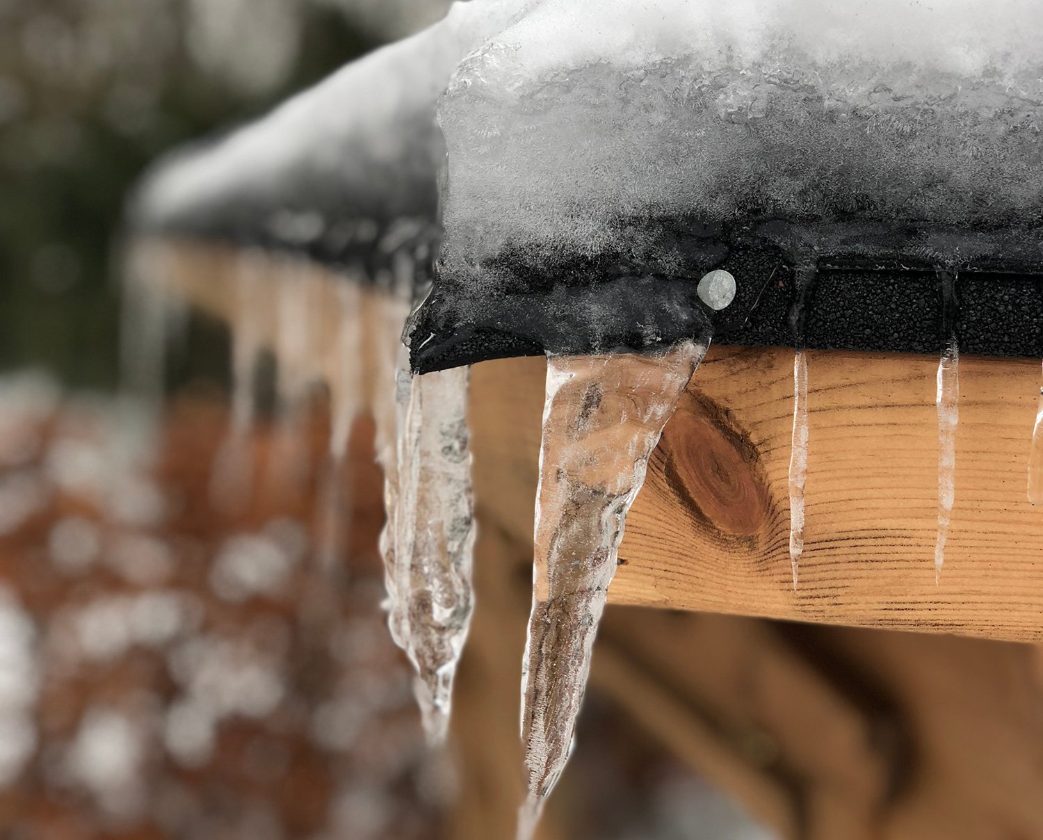 Close up of icicle hanging off the roof of an Arctic Cabin Grillkota hut