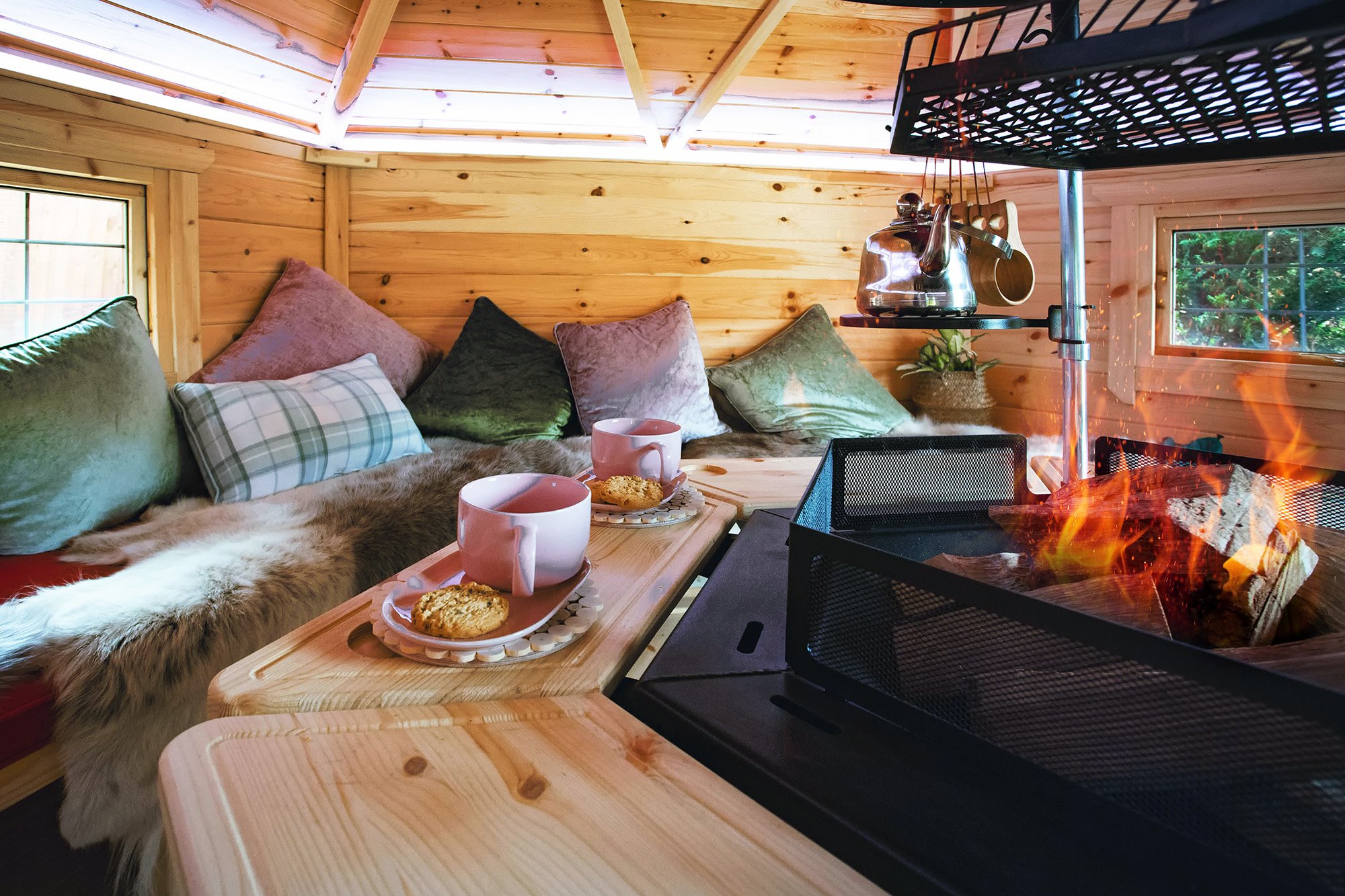 Cosy interior of a 10m² Arctic Cabin with tea & biscuits