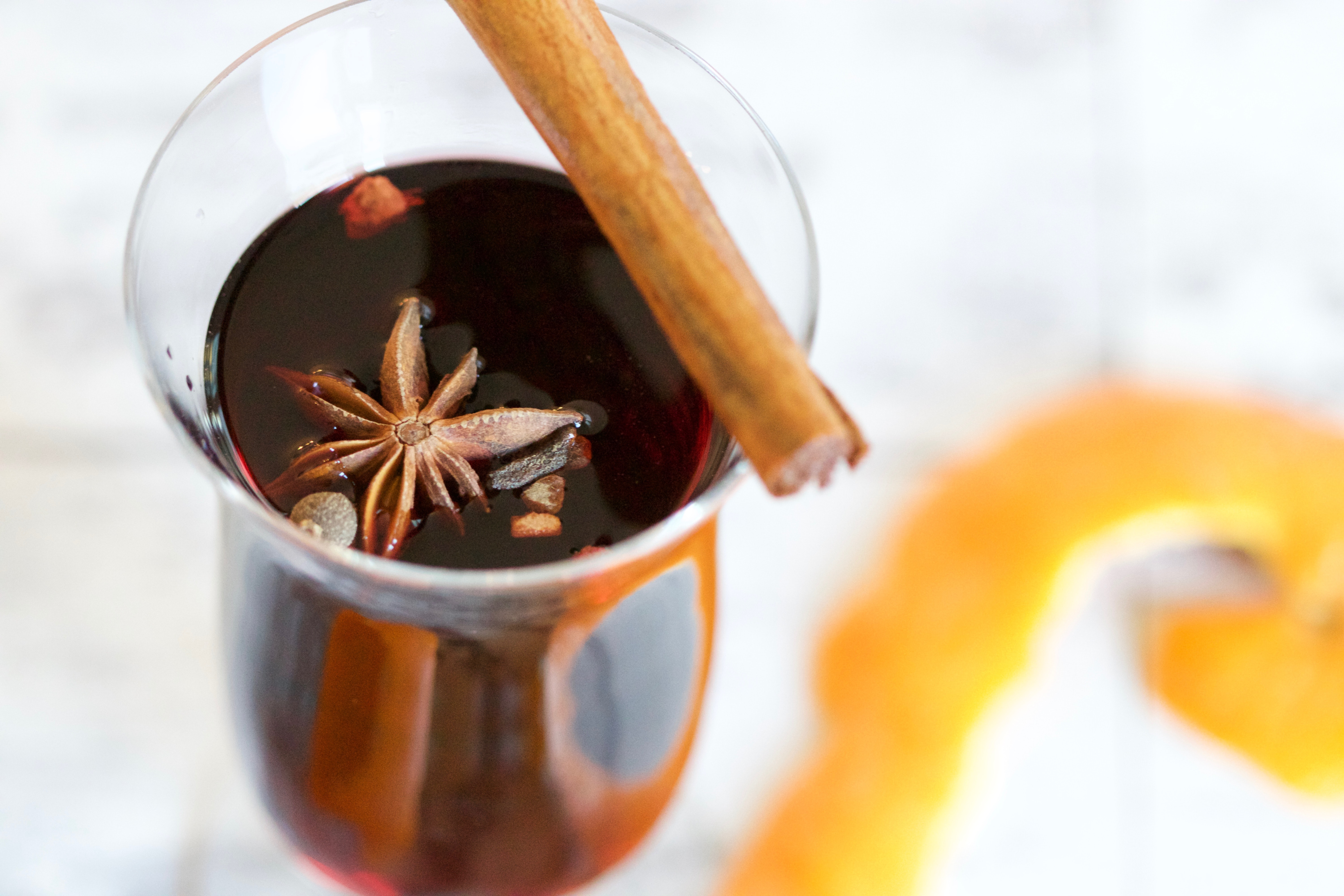 Glass of mulled wine with cinnamon stick and star anise