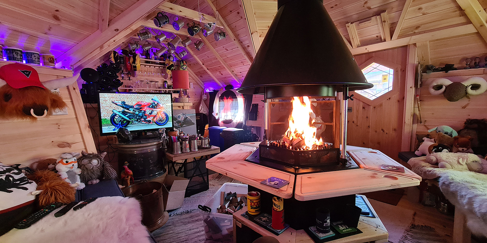 Interior of a BBQ cabin bar with fire lit and man cave decor