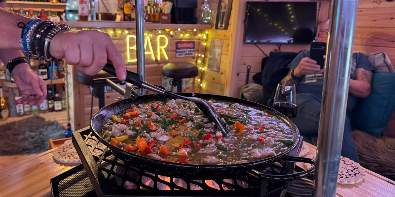 paella being cooked inside an Arctic Cabins bbq hut